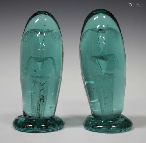 A pair of soda glass dump paperweights with internal tiered decoration, height 13.5cm.Buyer’s