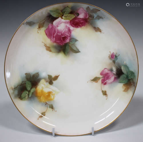 A Royal Worcester plate, circa 1913, painted by K.H. Blake, signed, with pink and yellow roses in