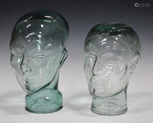 Two moulded glass display heads, heights 24.5cm and 28cm, together with a group of assorted drinking