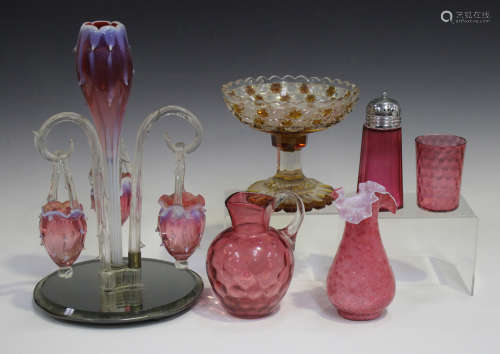An opalescent cranberry glass epergne, late 19th/early 20th century, the central tulip shaped vase