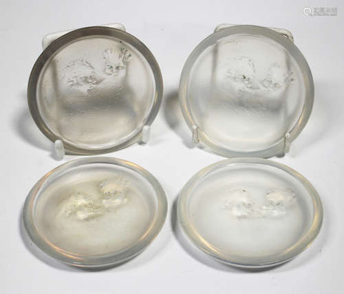 Four Art Deco Lalique opalescent glass Zéphyrs cendriers, pre-1945, each of circular shape,