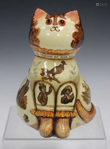 A Joan and David de Bethel Rye Pottery figure of a seated cat, dated 1969, its collar inscribed '