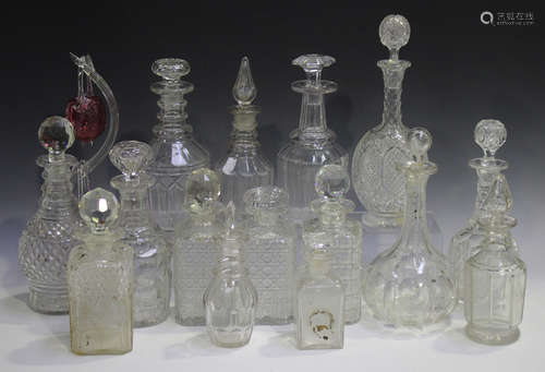 A mixed group of cut glass decanters and stoppers, mostly 19th century, including an American bright