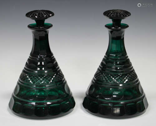 A pair of conical or Rodney shaped cut green glass decanters and stoppers, early 20th century,