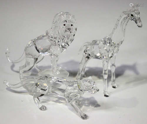 A Swarovski Crystal lion, designed by Martin Zendron, modelled standing on a rock, height 11.7cm,