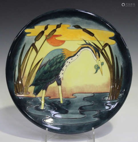 A Moorcroft Heron Reeds at Sunset pattern charger, circa 1992, designed by Philip Richardson,