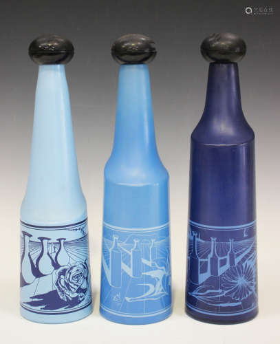 A set of three numbered Rosso Antico glass bottles after Salvador Dali, circa 1970, each of blue
