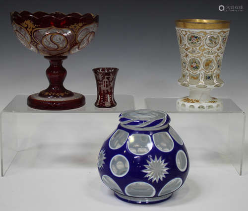 A Bohemian white overlay cut and enamelled glass vase, late 19th/early 20th century, the flared body