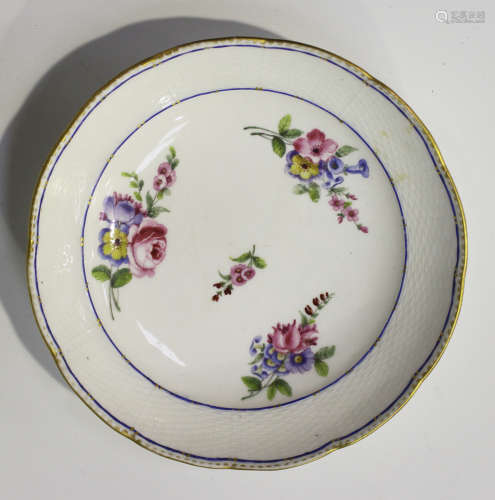A Sèvres porcelain circular saucer dish, mid-18th century, painted with three floral sprays around a