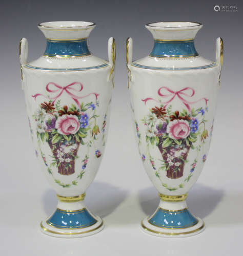 A pair of Minton Bicentenary Rose Basket two-handled vases of shield shape, decorated with flower