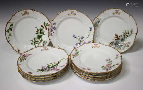 A set of twelve Limoges plates, early 20th century, painted with different flowers and insects below