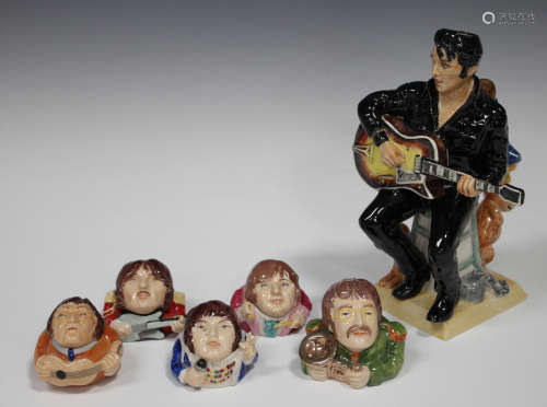 A prototype Kevin Francis model of Elvis Presley, modelled seated playing his guitar, painted in