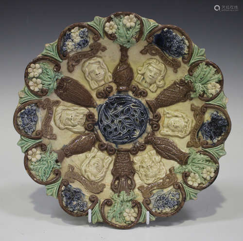 A Castle Hedingham pottery circular dish by Edward Bingham, late 19th century, decorated in relief