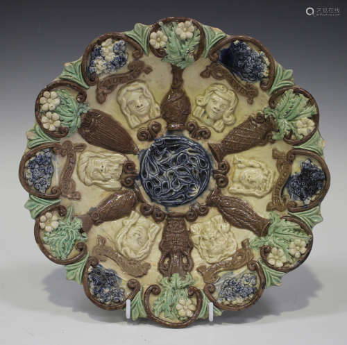 A Castle Hedingham pottery circular dish by Edward Bingham, late 19th century, decorated in relief