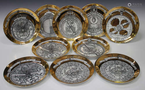 Ten Fornasetti porcelain Astrolabio plates, 1970s, each printed in black against a gilt ground,