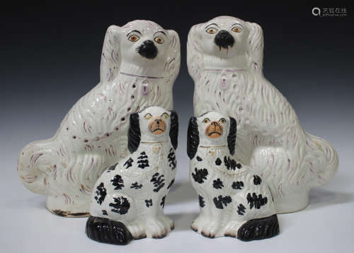 A large pair of Staffordshire spaniels, late 19th century, white glazed with lustre detailing,