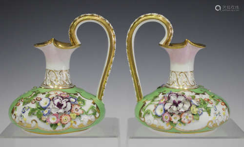 A pair of Bloor Derby floral encrusted green ground jugs, circa 1820-40, each bulbous body beneath a