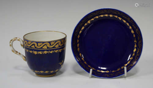A Vincennes bleu lapis ground porcelain cup and saucer, circa 1750, the cup gilt with a foliate