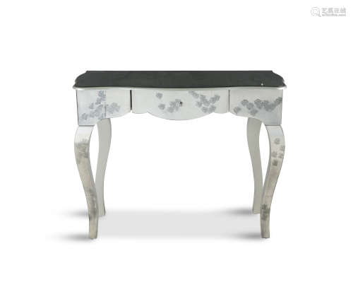 A MODERN MIRRORED SERPENTINE SIDE TABLE, the mirrored top above single frieze drawer, raised on