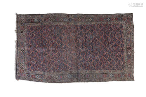 A PERSIAN RUG, the long rectangular reserve woven with rows of geometric pattern against a red