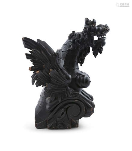 A LARGE CARVED OAK MODEL OF A WINGED GARGOYLE, 18th century, modelled perched on a scrollwork