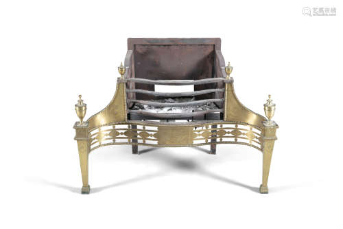 A GEORGE III BRASS AND CAST IRON FIRE GRATE, c.1790, of serpentine form, with three bar grill