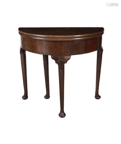 AN IRISH GEORGE II MAHOGANY FOLD-TOP D-SHAPED TABLE, with gate leg action support and plain frieze