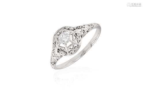 A DIAMOND RING, the brilliant-cut diamond set within an openwork of foliate design, to a plain hoop,