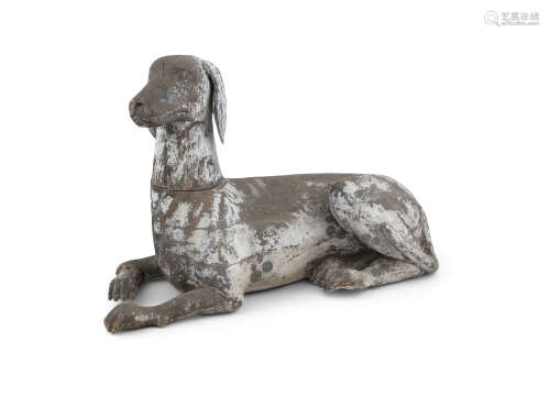 A CHINESE CARVED WOOD MODEL OF A HUNTING DOG, Qing Dynasty (1644 - 1912) in recumbent pose. 62cm
