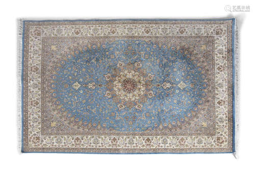 A PERSIAN BLUE GROUND WOOL CARPET, the rectangular centre field with circular medallion tendrils and