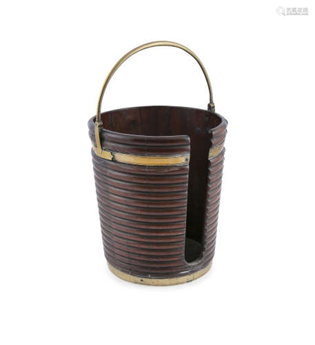 A GEORGE III MAHOGANY BRASS BOUND FUEL BUCKET, of coopered construction, ribbed body and brass swing