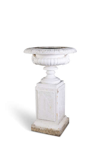 A VICTORIAN CAST IRON GARDEN URN, the broad top with everted rim above a waisted pedestal foot,