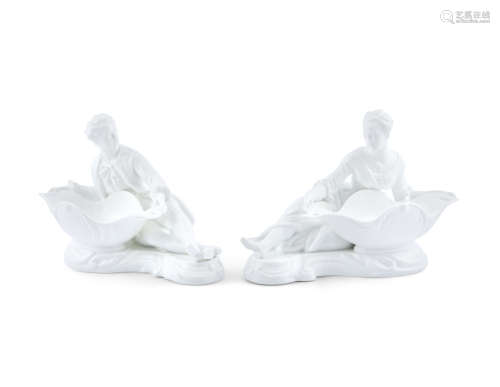 A PAIR OF BLANC DE CHINE FIGURAL TABLE ORNAMENTS, in the form of recumbent male and female figures