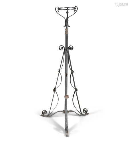 A VICTORIAN WROUGHT IRON PLANT STAND, raised on a central pillar and tripod scrolling supports.