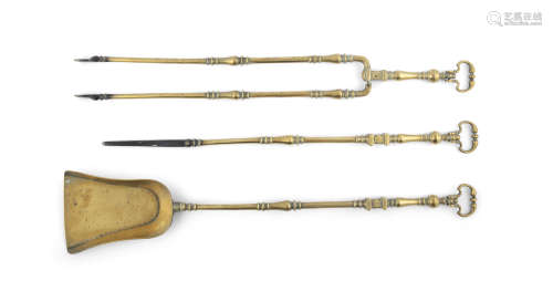 A SET OF THREE MID 19TH CENTURY FIRE BRASSES with cartouche shaped handles, each 80cm long