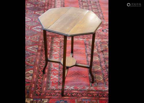 An Arts and Crafts walnut octagonal drop leaf occasional table, with swivel solid legs to lock in