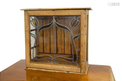 A glazed pine cabinet, the three glazed sides with hinged door with astragal glazed Art Nouveau