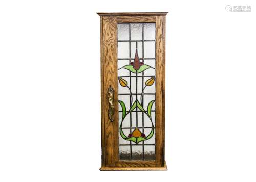 An Art Nouveau lead glass glazed cabinet, of composite form with applied lead glass panel and Art