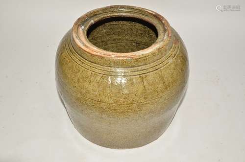 A large stoneware celadon glazed ginger jar, lacking lid, the bulbous body with tapered short