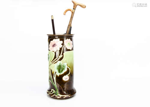 A large continental Art Nouveau majolica stick stand, of cylindrical form decorated with pink