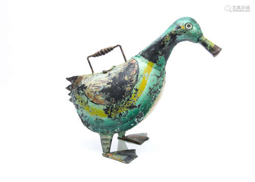 A novelty watering can, in tin modelled as a duck, the two feet supporting duck's body with open