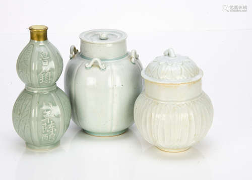 A contemporary double gourd celadon glazed sake bottle, with contents with gold wax top, 21.5cm high