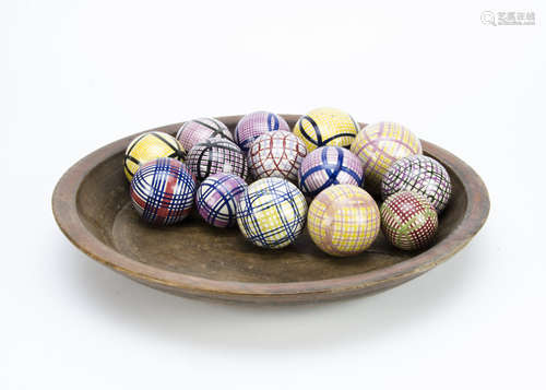 A treen circular bowl with a collection of Scottish terracotta carpet bowls, in cross hatch and