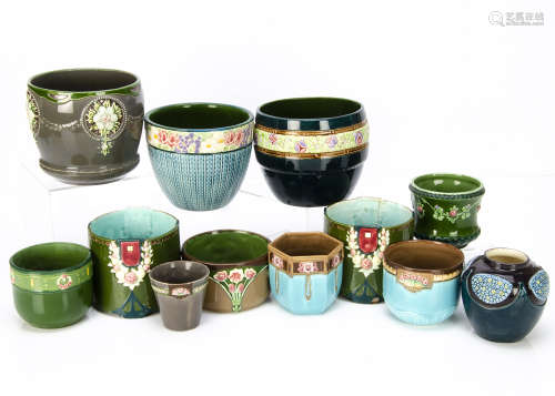 A collection of twelve small Eichwald Art Nouveau German pottery plant pots, jardinières and