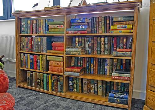 An Edwardian pine three quarter height bookcase, fitted with four shelves in two sections, 159cm