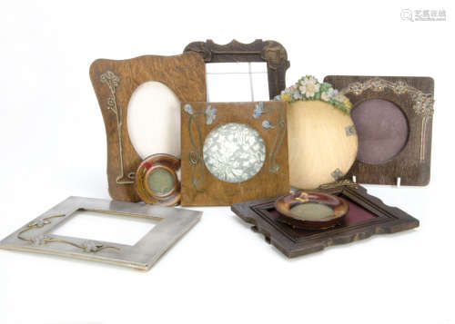 A collection of floral decorated photograph frames, including a small boxwood example with pink