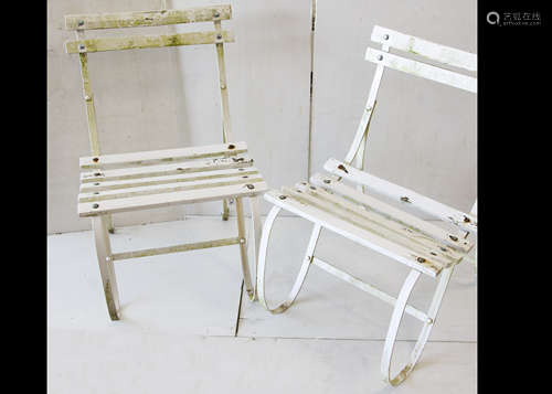 Four white painted garden chairs, the roll metal strapwork with wooden slatted seats and back, one