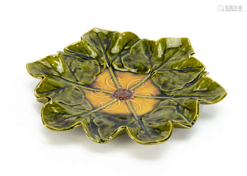 A Bretby moulded pottery dish, modelled as a wreath of leaves centred with flower head, the ochre