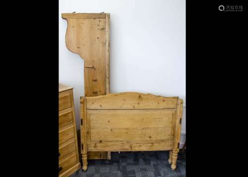 A continental pitch pine single bed, with shaped sides and head and foot boards, 117cm wide x 95cm