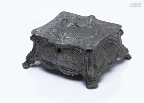A continental pewter jewellery box, the cushion shaped box with hinged lid decorated with courting